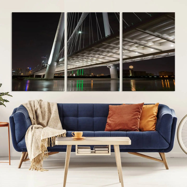 A modern living room showcases the "Dallas City Lights" night skyline cityscape as a triptych on museum-quality canvas. Enjoy the art's longevity with its UV-protective coating, all available with free shipping.