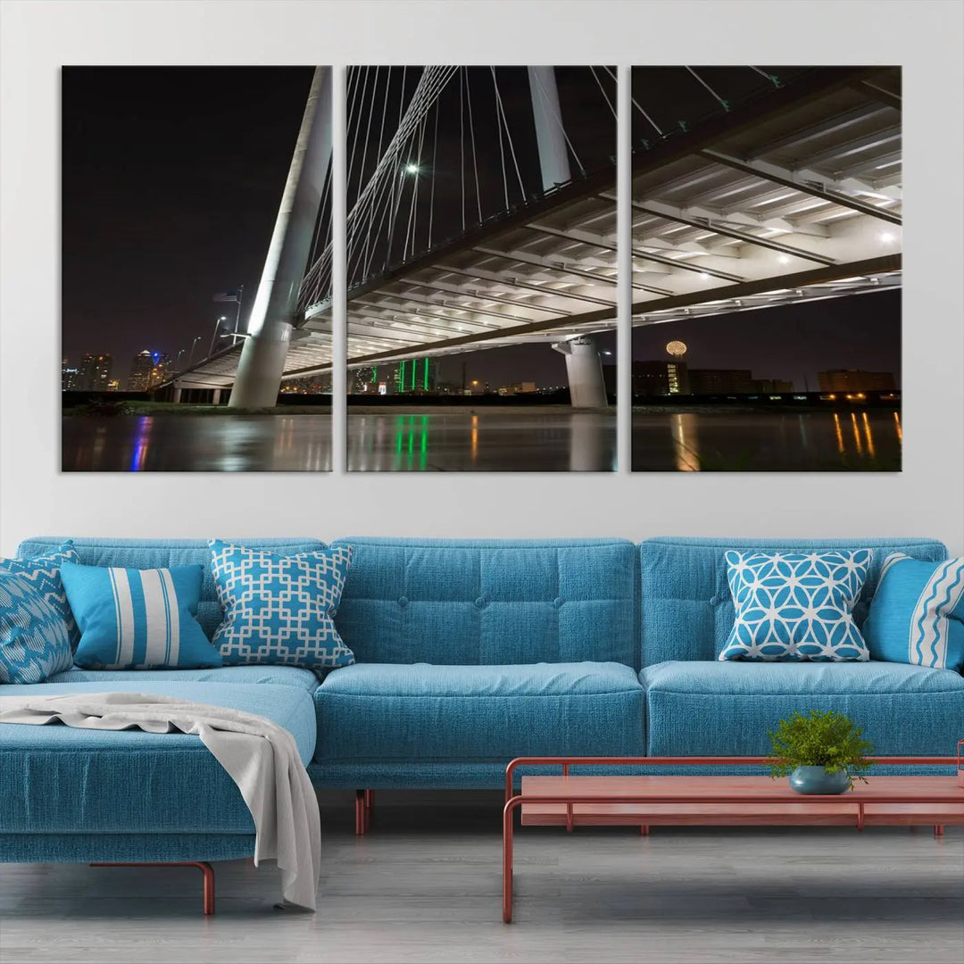 A modern living room showcases the "Dallas City Lights" night skyline cityscape as a triptych on museum-quality canvas. Enjoy the art's longevity with its UV-protective coating, all available with free shipping.