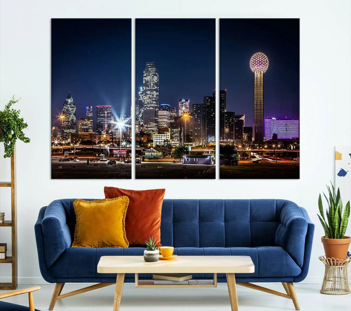 A living room showcases the Dallas City Lights Night Skyline Cityscape View Wall Art Canvas Print, a triptych photo of a city skyline at night on museum-quality canvas that is ready to hang.