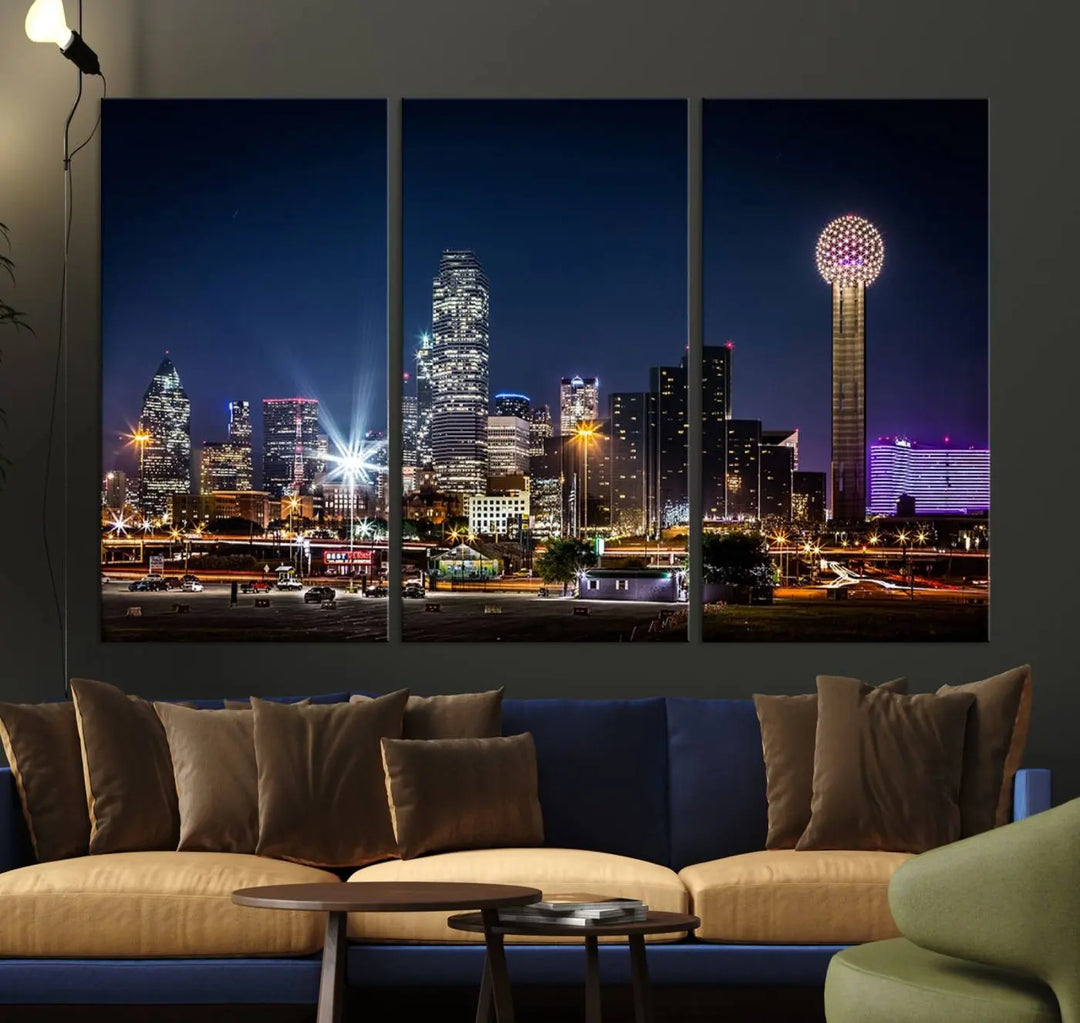 A living room showcases the Dallas City Lights Night Skyline Cityscape View Wall Art Canvas Print, a triptych photo of a city skyline at night on museum-quality canvas that is ready to hang.