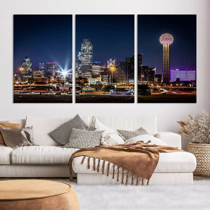 A living room showcases the Dallas City Lights Night Skyline Cityscape View Wall Art Canvas Print, a triptych photo of a city skyline at night on museum-quality canvas that is ready to hang.