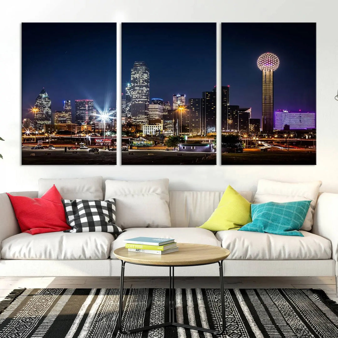 A living room showcases the Dallas City Lights Night Skyline Cityscape View Wall Art Canvas Print, a triptych photo of a city skyline at night on museum-quality canvas that is ready to hang.