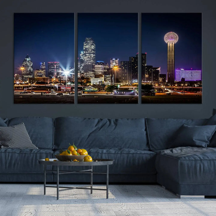 A living room showcases the Dallas City Lights Night Skyline Cityscape View Wall Art Canvas Print, a triptych photo of a city skyline at night on museum-quality canvas that is ready to hang.