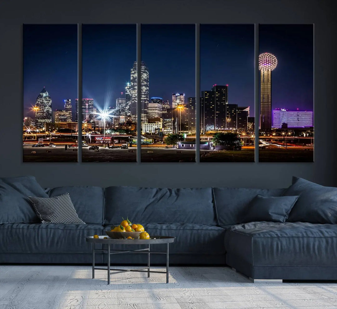 A living room showcases the Dallas City Lights Night Skyline Cityscape View Wall Art Canvas Print, a triptych photo of a city skyline at night on museum-quality canvas that is ready to hang.