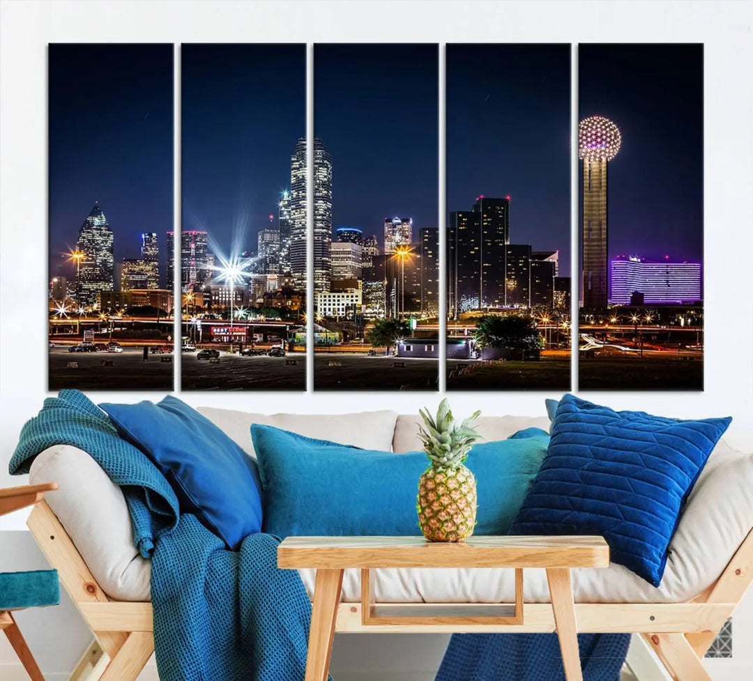 A living room showcases the Dallas City Lights Night Skyline Cityscape View Wall Art Canvas Print, a triptych photo of a city skyline at night on museum-quality canvas that is ready to hang.