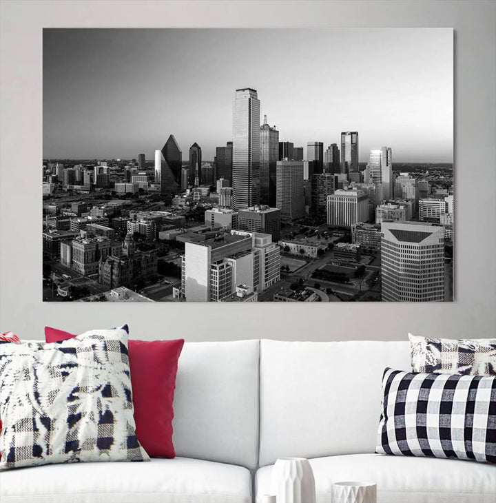 A modern living room showcases the Dallas City Lights Skyline Black and White Wall Art Cityscape Canvas Print. This gallery-wrapped piece offers a sleek finish and is crafted from museum-quality pollycotton. It features a UV-protective coating to ensure lasting vibrancy.