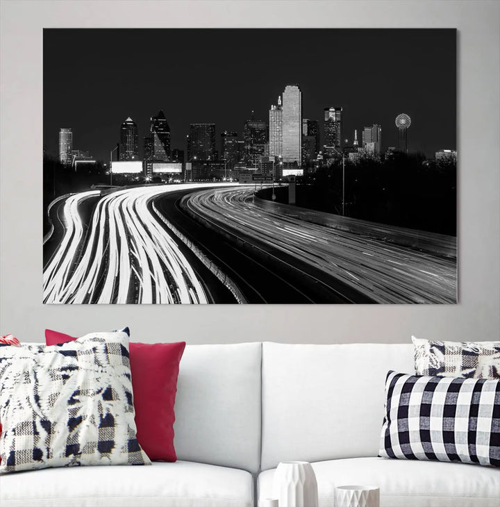 The Dallas City Street Lights Skyline Black and White Wall Art Cityscape Canvas Print features a triptych of a city skyline with light trails. Crafted on museum-quality canvas with a UV-protective coating, this ready-to-hang artwork enhances any contemporary space with its striking urban aesthetic.