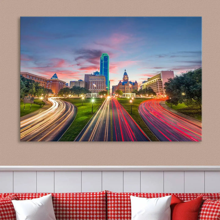 A modern living room features a cityscape triptych wall art titled "Dallas City Street Lights Sunset Pink Cloudy Skyline Cityscape View," printed on museum-quality canvas. It captures a vibrant evening skyline with light trails.