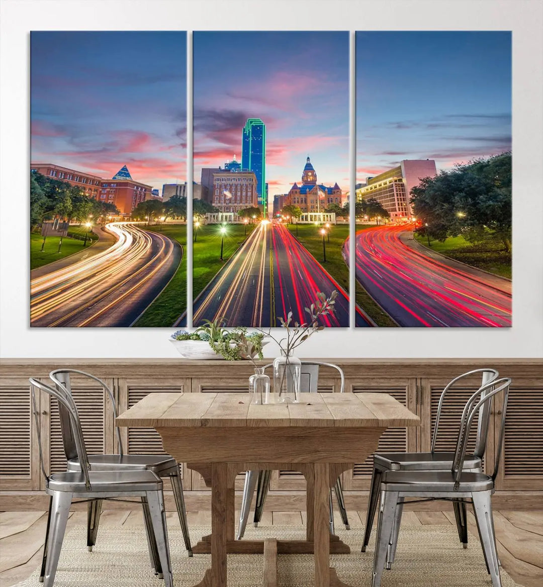 A modern living room features a cityscape triptych wall art titled "Dallas City Street Lights Sunset Pink Cloudy Skyline Cityscape View," printed on museum-quality canvas. It captures a vibrant evening skyline with light trails.