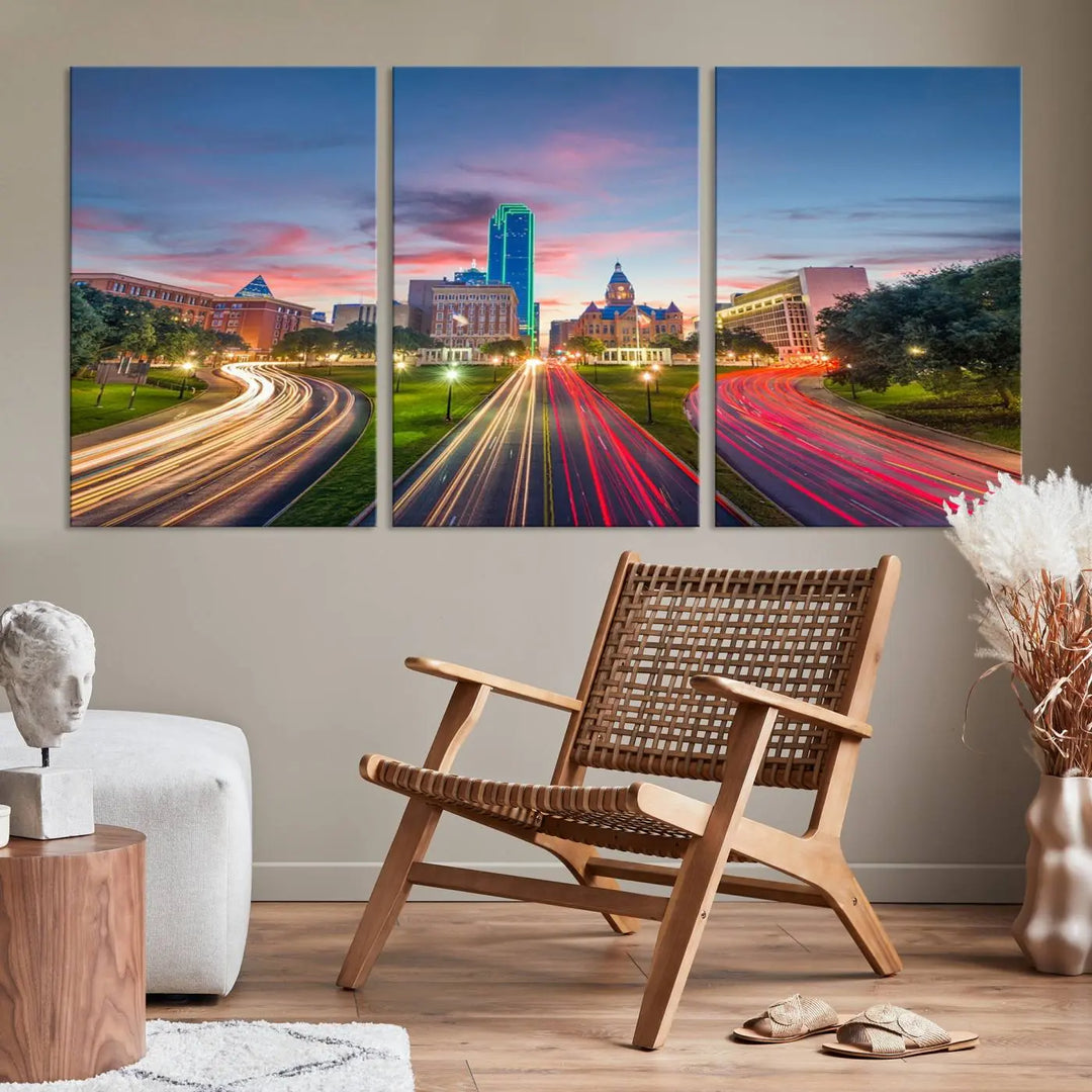 A modern living room features a cityscape triptych wall art titled "Dallas City Street Lights Sunset Pink Cloudy Skyline Cityscape View," printed on museum-quality canvas. It captures a vibrant evening skyline with light trails.