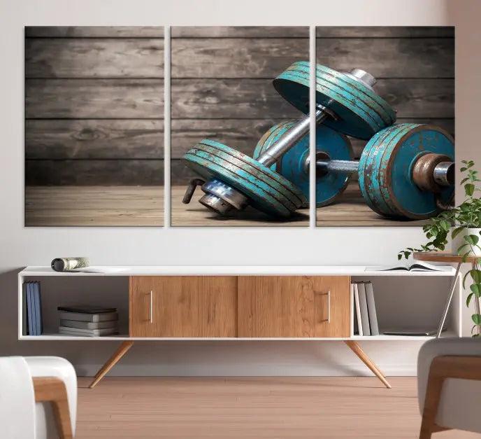 Adorn your walls with the Dambell and Sport Wall Art Canvas Print, showcasing teal dumbbells against rustic wooden panels for a touch of museum-quality elegance.