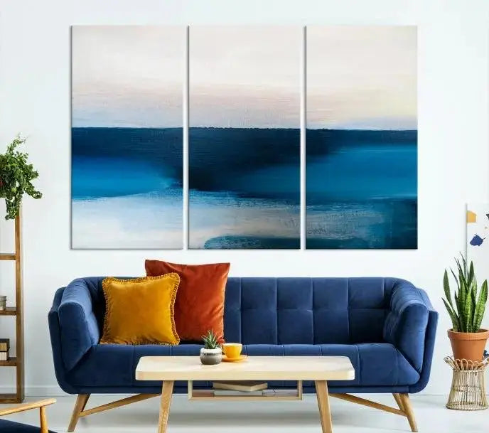 The living room is enhanced by the Dark Blue Abstract Wall Art Canvas Print, a triptych painting on hand-assembled framed canvas with UV-protective coating for enduring vibrancy.