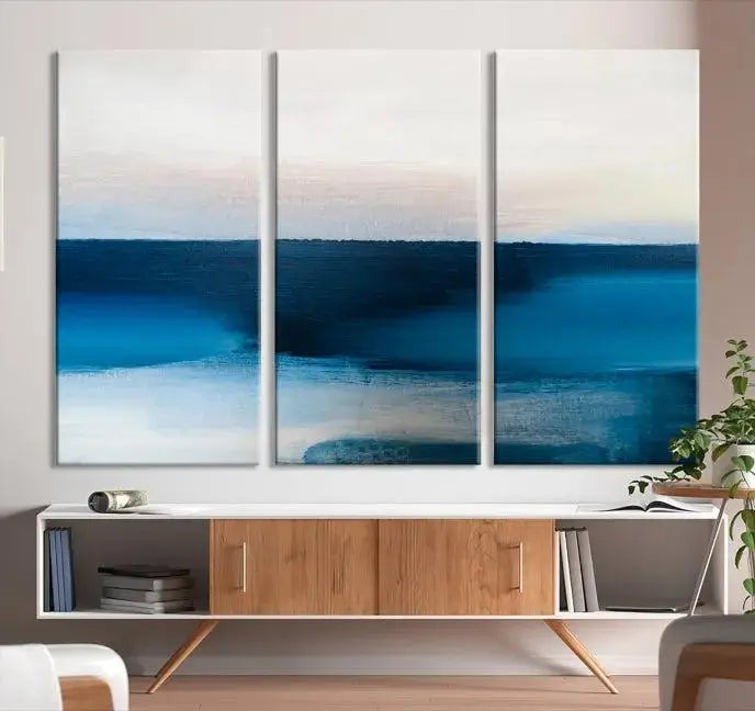 The living room is enhanced by the Dark Blue Abstract Wall Art Canvas Print, a triptych painting on hand-assembled framed canvas with UV-protective coating for enduring vibrancy.