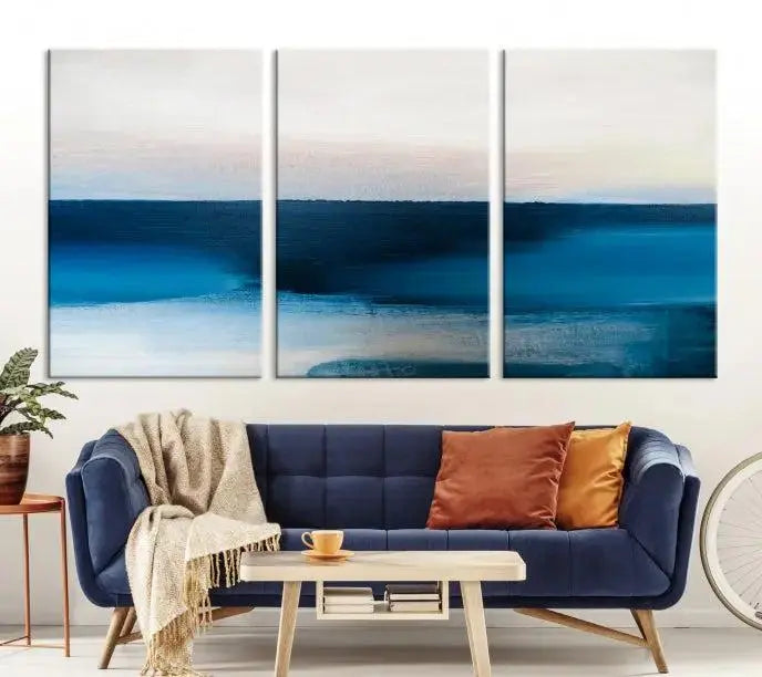 The living room is enhanced by the Dark Blue Abstract Wall Art Canvas Print, a triptych painting on hand-assembled framed canvas with UV-protective coating for enduring vibrancy.