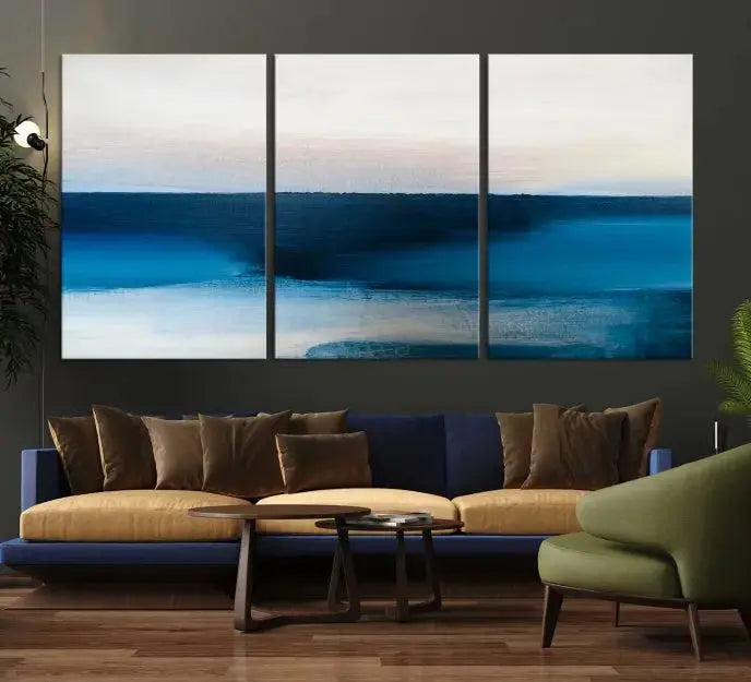 The living room is enhanced by the Dark Blue Abstract Wall Art Canvas Print, a triptych painting on hand-assembled framed canvas with UV-protective coating for enduring vibrancy.