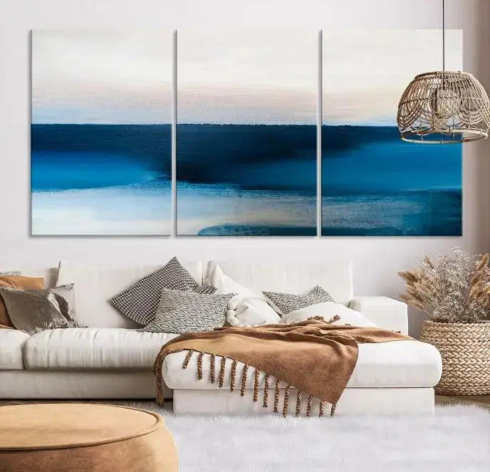 The living room is enhanced by the Dark Blue Abstract Wall Art Canvas Print, a triptych painting on hand-assembled framed canvas with UV-protective coating for enduring vibrancy.