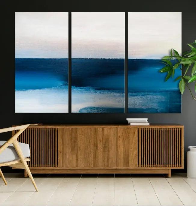 The living room is enhanced by the Dark Blue Abstract Wall Art Canvas Print, a triptych painting on hand-assembled framed canvas with UV-protective coating for enduring vibrancy.