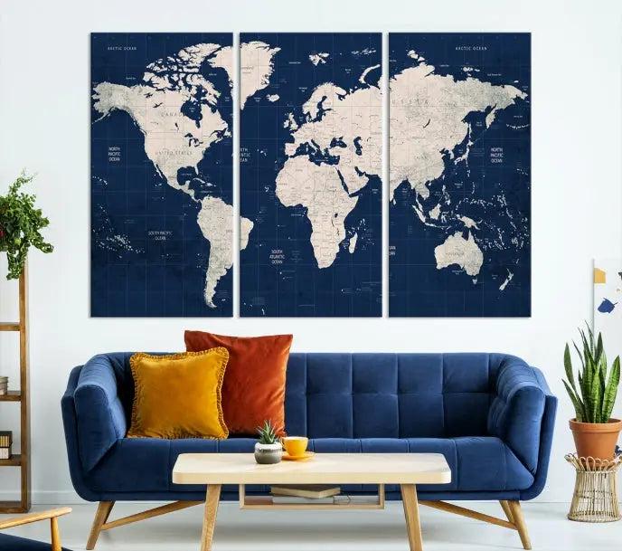 The modern living room is beautifully accented by the Dark Blue World Map Wall Art Canvas Print. This gallery-wrapped triptych features a dark blue backdrop that adds depth, creating a canvas of elegance on the wall.