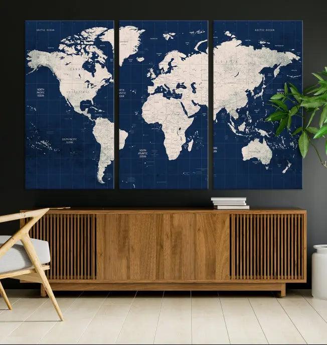 The modern living room is beautifully accented by the Dark Blue World Map Wall Art Canvas Print. This gallery-wrapped triptych features a dark blue backdrop that adds depth, creating a canvas of elegance on the wall.