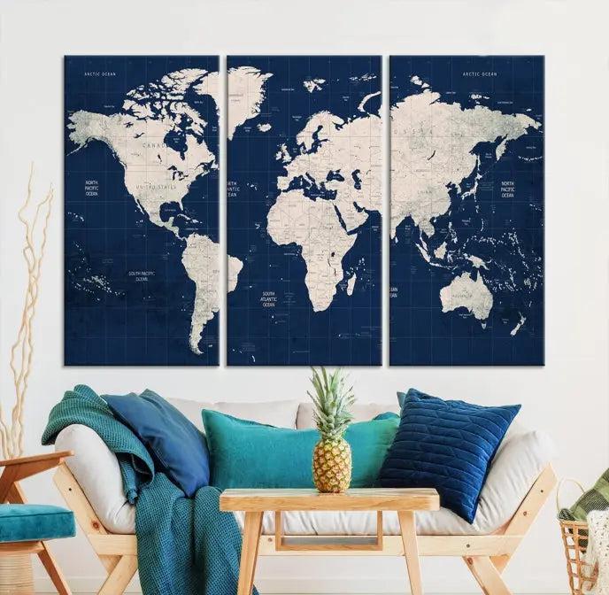 The modern living room is beautifully accented by the Dark Blue World Map Wall Art Canvas Print. This gallery-wrapped triptych features a dark blue backdrop that adds depth, creating a canvas of elegance on the wall.