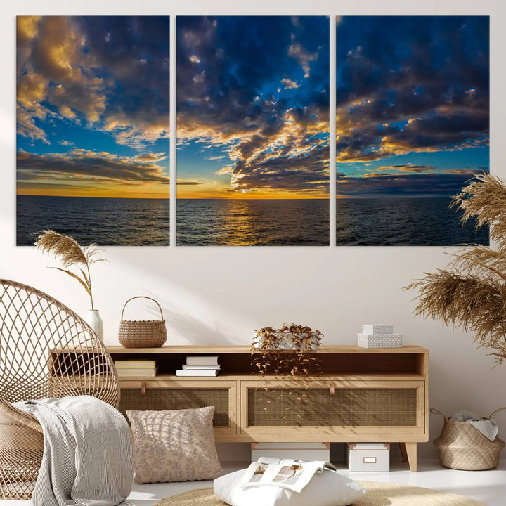 In a cozy living room, the Dark Clouds on the Ocean Beach Sunset Wall Art Canvas Print, featuring three panels and a museum-quality finish, hangs prominently.