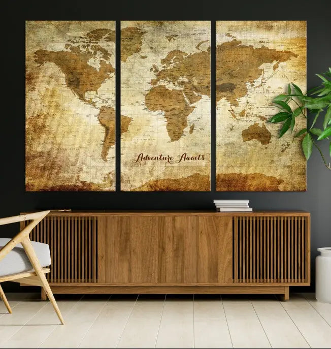 A Dark Theme World Map wall art canvas print, featuring the inspiring text "Adventure Awaits," hangs in this modern room. The map is crafted from museum-quality canvas and coated for UV protection, making it ready to hang.