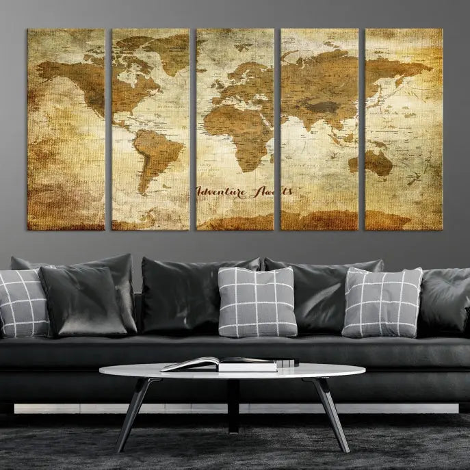 A Dark Theme World Map wall art canvas print, featuring the inspiring text "Adventure Awaits," hangs in this modern room. The map is crafted from museum-quality canvas and coated for UV protection, making it ready to hang.