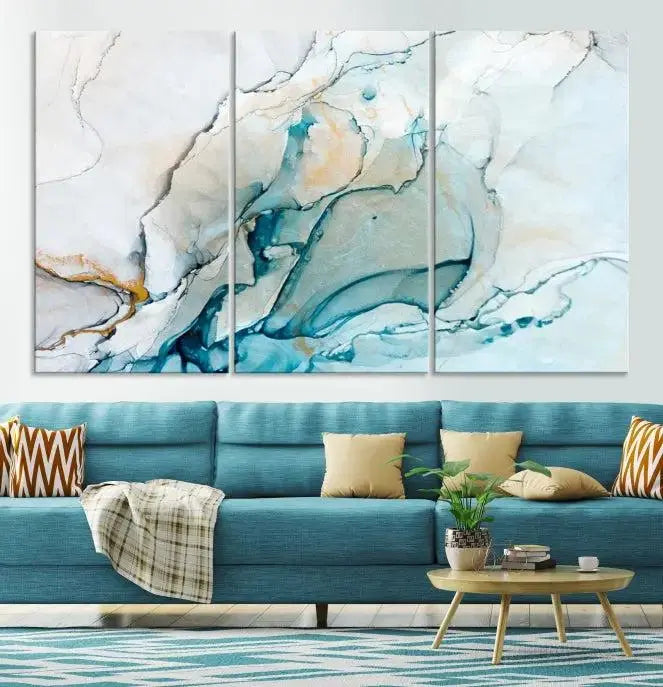 An abstract triptych of the Dark Turquoise Marble Fluid Effect on museum-quality canvas enhances the living room.