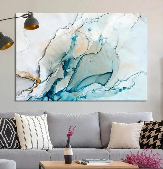 An abstract triptych of the Dark Turquoise Marble Fluid Effect on museum-quality canvas enhances the living room.