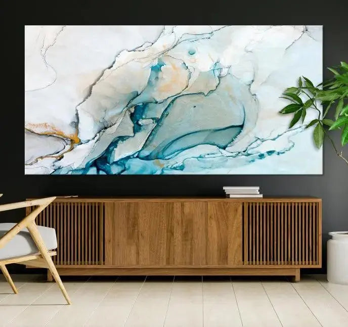 An abstract triptych of the Dark Turquoise Marble Fluid Effect on museum-quality canvas enhances the living room.