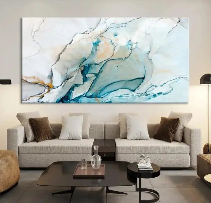 An abstract triptych of the Dark Turquoise Marble Fluid Effect on museum-quality canvas enhances the living room.