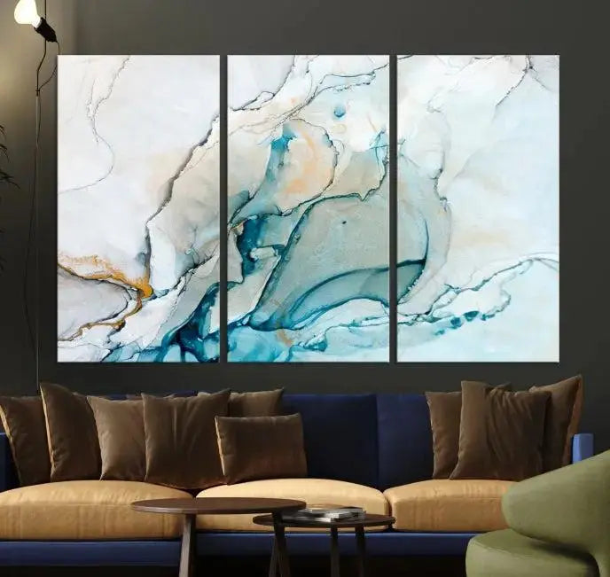 An abstract triptych of the Dark Turquoise Marble Fluid Effect on museum-quality canvas enhances the living room.