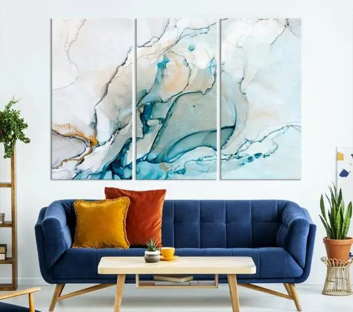 An abstract triptych of the Dark Turquoise Marble Fluid Effect on museum-quality canvas enhances the living room.