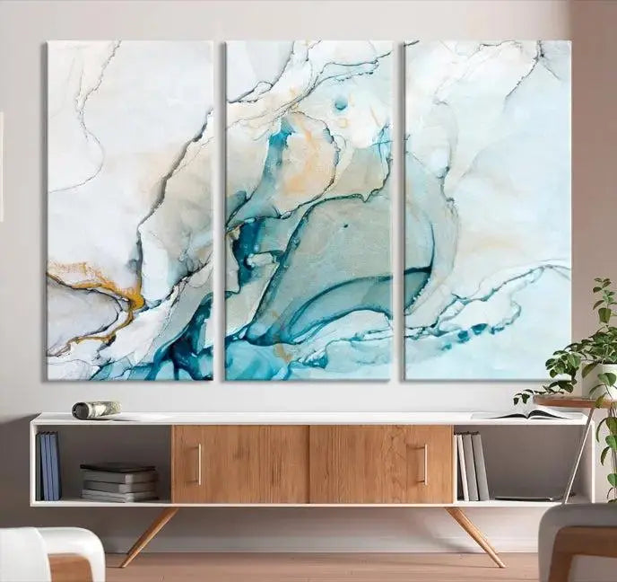 An abstract triptych of the Dark Turquoise Marble Fluid Effect on museum-quality canvas enhances the living room.