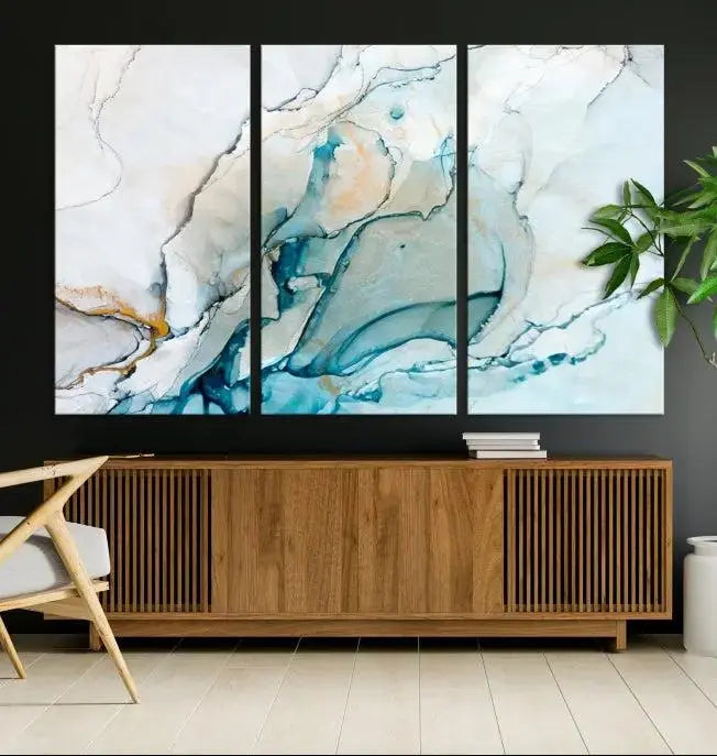 An abstract triptych of the Dark Turquoise Marble Fluid Effect on museum-quality canvas enhances the living room.