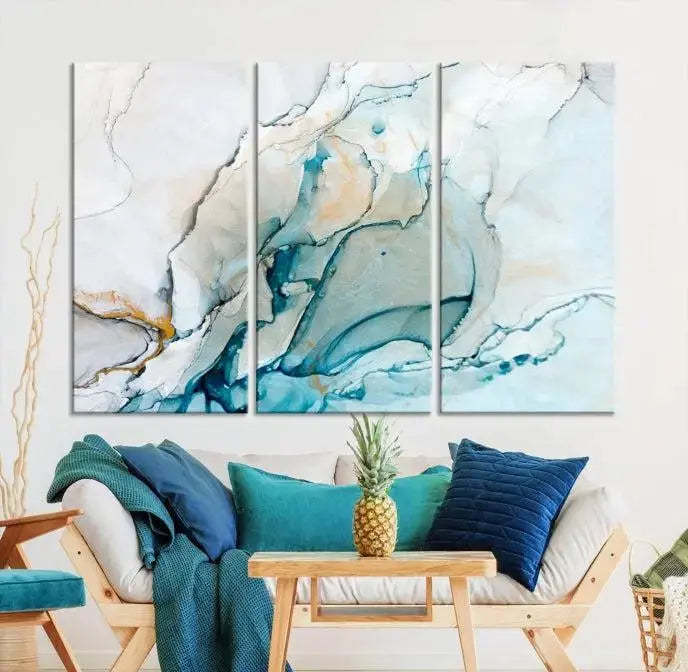 An abstract triptych of the Dark Turquoise Marble Fluid Effect on museum-quality canvas enhances the living room.