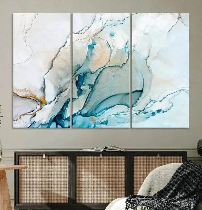 An abstract triptych of the Dark Turquoise Marble Fluid Effect on museum-quality canvas enhances the living room.