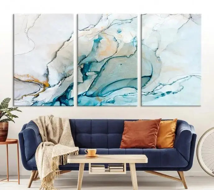 An abstract triptych of the Dark Turquoise Marble Fluid Effect on museum-quality canvas enhances the living room.