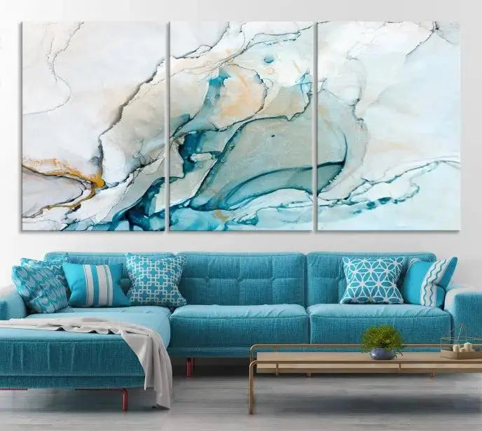 An abstract triptych of the Dark Turquoise Marble Fluid Effect on museum-quality canvas enhances the living room.