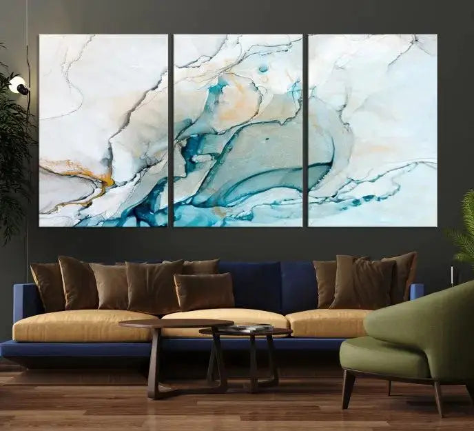 An abstract triptych of the Dark Turquoise Marble Fluid Effect on museum-quality canvas enhances the living room.