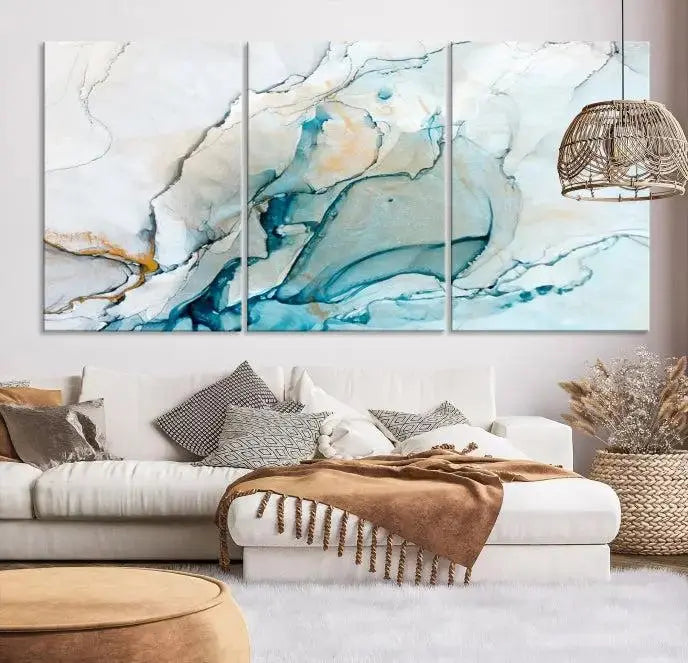 An abstract triptych of the Dark Turquoise Marble Fluid Effect on museum-quality canvas enhances the living room.