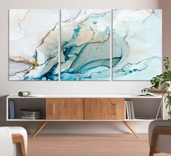 An abstract triptych of the Dark Turquoise Marble Fluid Effect on museum-quality canvas enhances the living room.