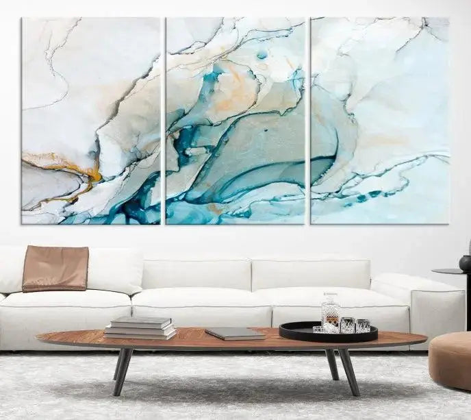 An abstract triptych of the Dark Turquoise Marble Fluid Effect on museum-quality canvas enhances the living room.