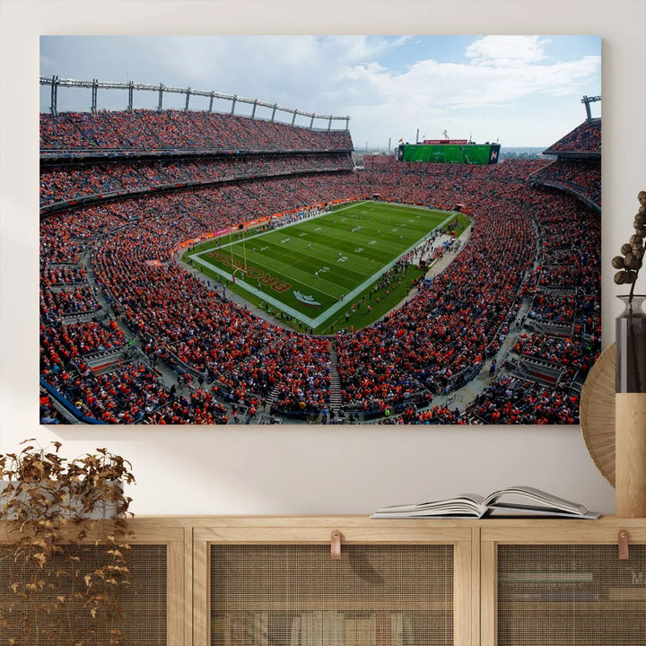 A triptych wall art titled "Denver Broncos Football Team Print - Empower Field at Mile High Stadium" is crafted on museum-quality canvas using high-resolution printing for stunning detail.