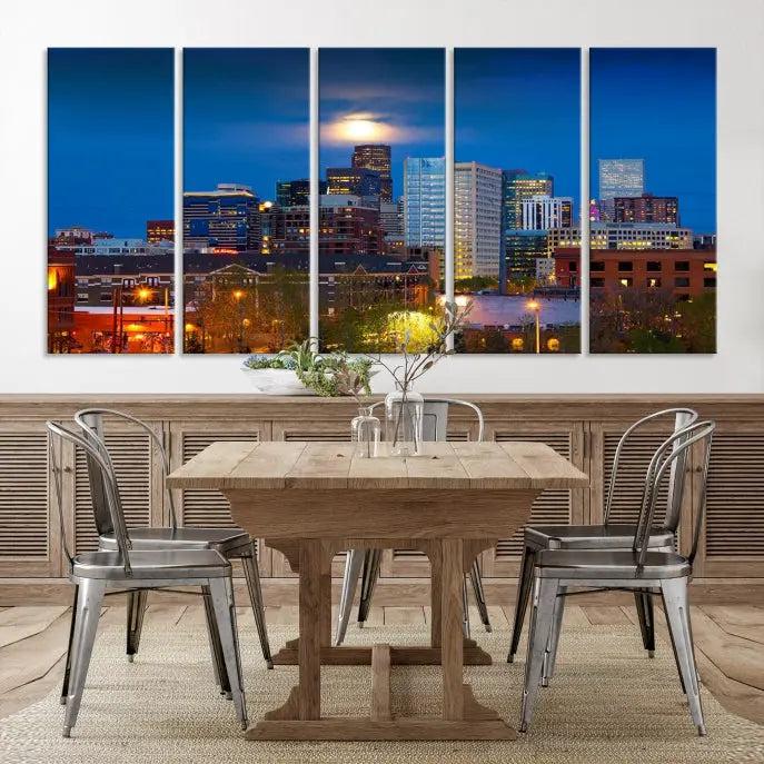 The Denver City Lights Night Blue Skyline Cityscape View Wall Art Canvas Print captures a stunning skyline at night with illuminated buildings and a bright moon, presented on gallery-quality canvas for an elegant display.