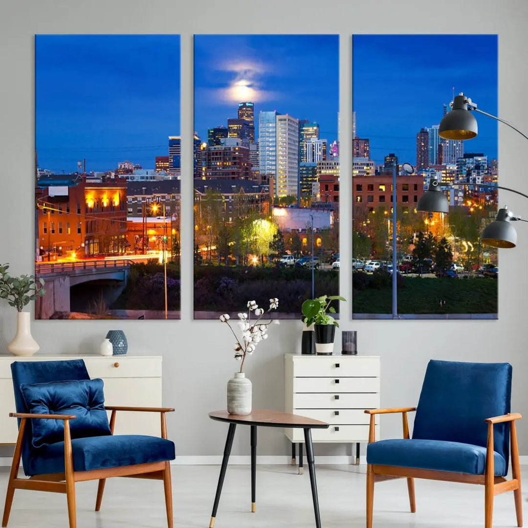 The Denver City Lights Night Blue Skyline Cityscape View Wall Art Canvas Print showcases a stunning night cityscape. Printed on museum-quality canvas with a UV-protective coating, this artwork comes ready to hang, adding an effortless touch of elegance.