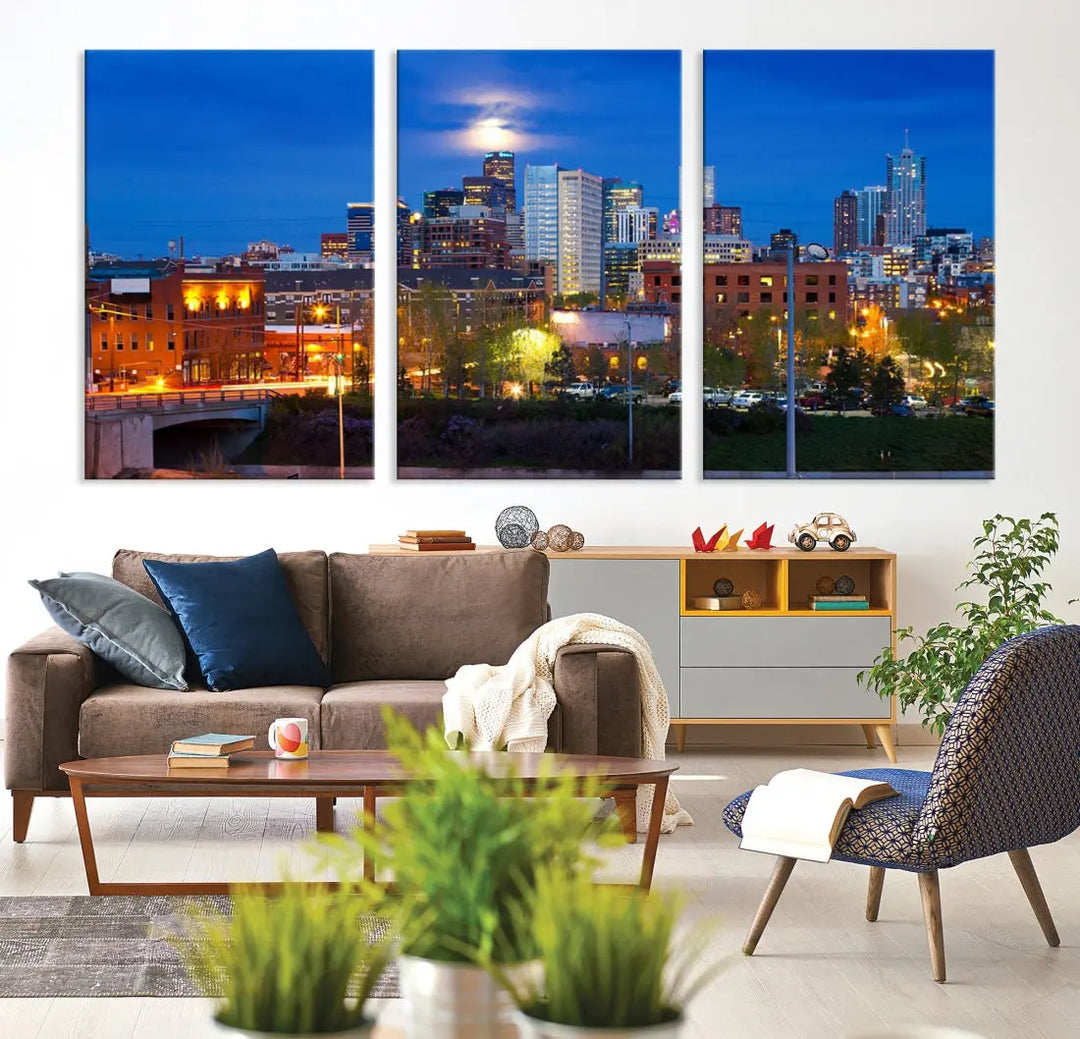 The Denver City Lights Night Blue Skyline Cityscape View Wall Art Canvas Print showcases a stunning night cityscape. Printed on museum-quality canvas with a UV-protective coating, this artwork comes ready to hang, adding an effortless touch of elegance.