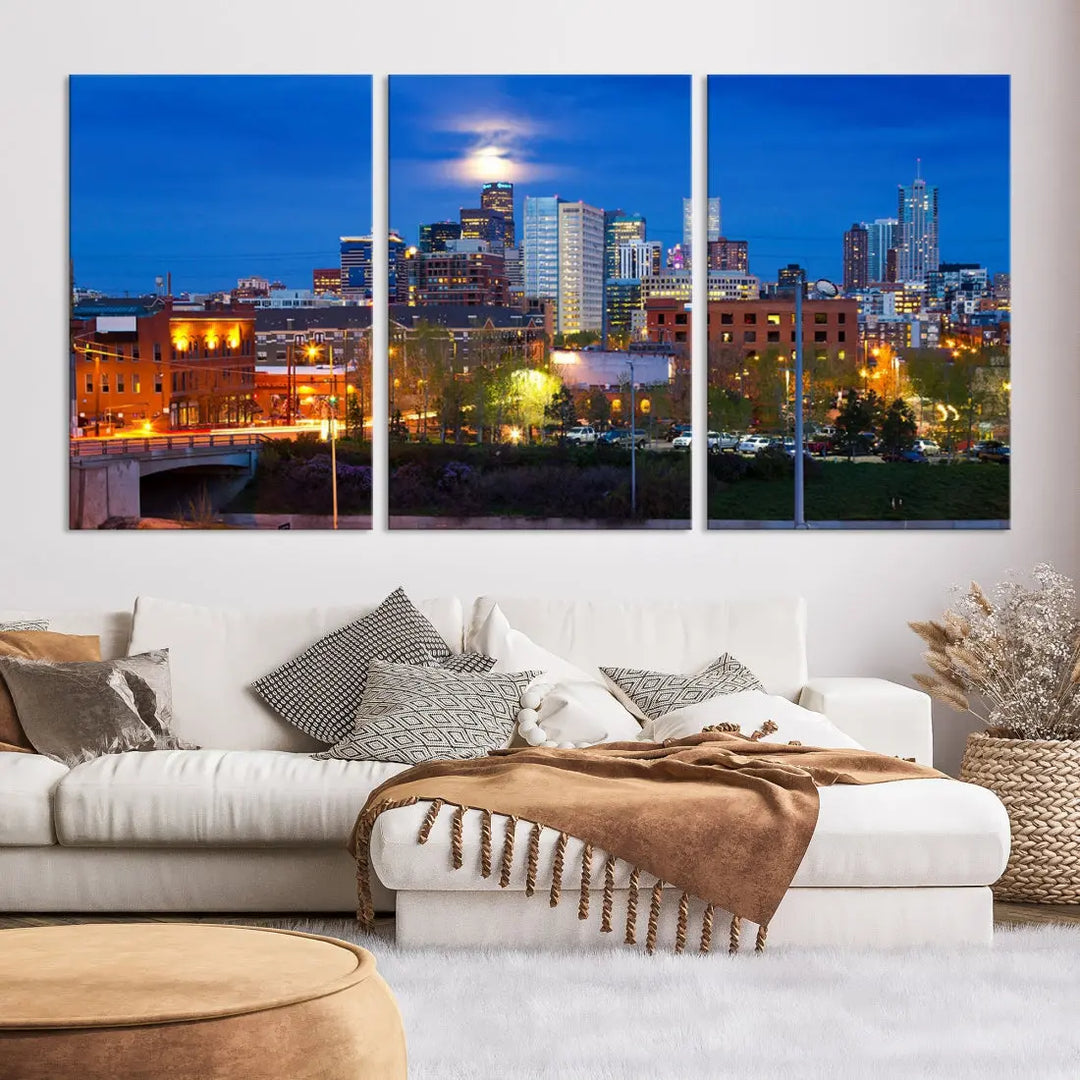 The Denver City Lights Night Blue Skyline Cityscape View Wall Art Canvas Print showcases a stunning night cityscape. Printed on museum-quality canvas with a UV-protective coating, this artwork comes ready to hang, adding an effortless touch of elegance.