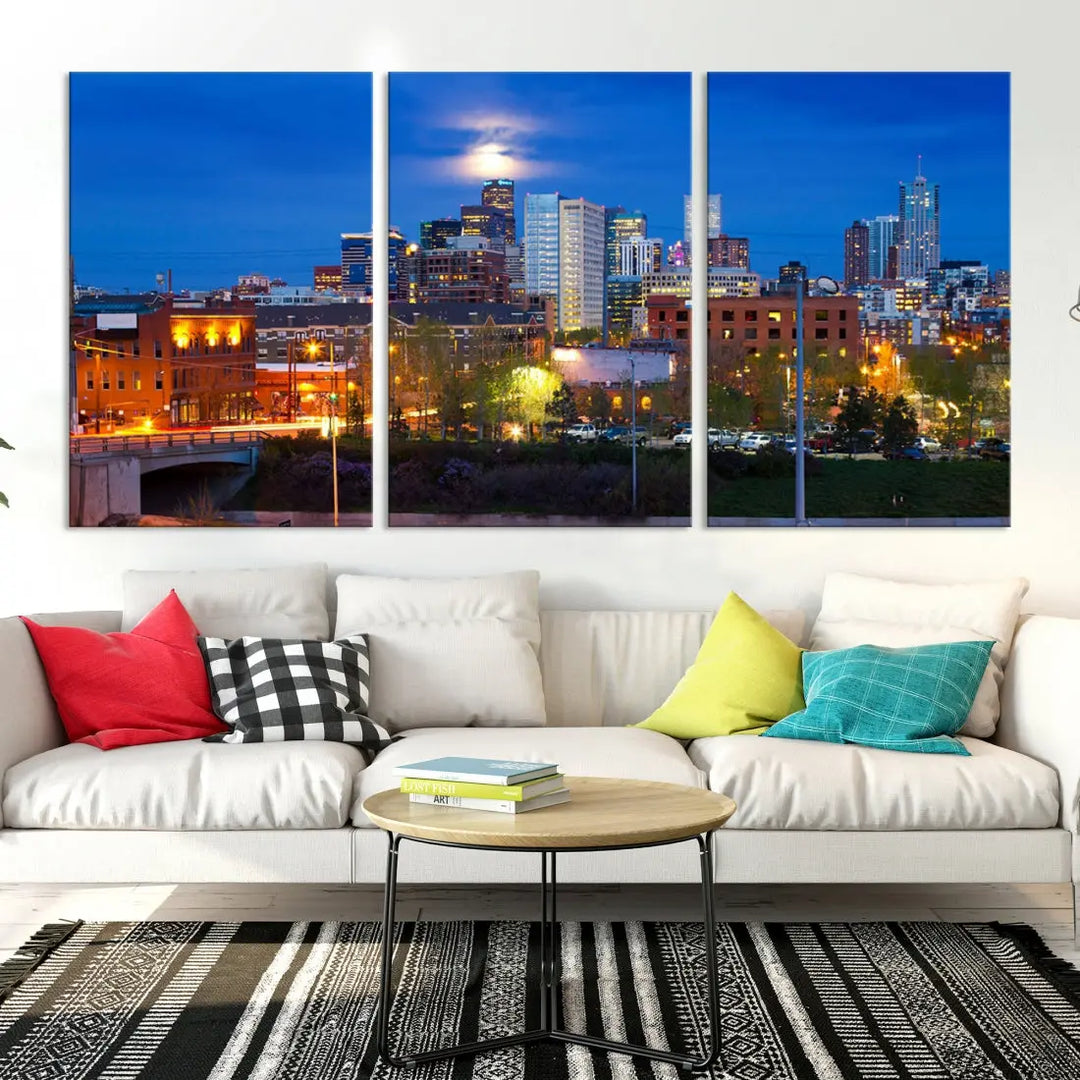 The Denver City Lights Night Blue Skyline Cityscape View Wall Art Canvas Print showcases a stunning night cityscape. Printed on museum-quality canvas with a UV-protective coating, this artwork comes ready to hang, adding an effortless touch of elegance.