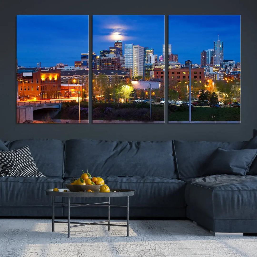 The Denver City Lights Night Blue Skyline Cityscape View Wall Art Canvas Print showcases a stunning night cityscape. Printed on museum-quality canvas with a UV-protective coating, this artwork comes ready to hang, adding an effortless touch of elegance.